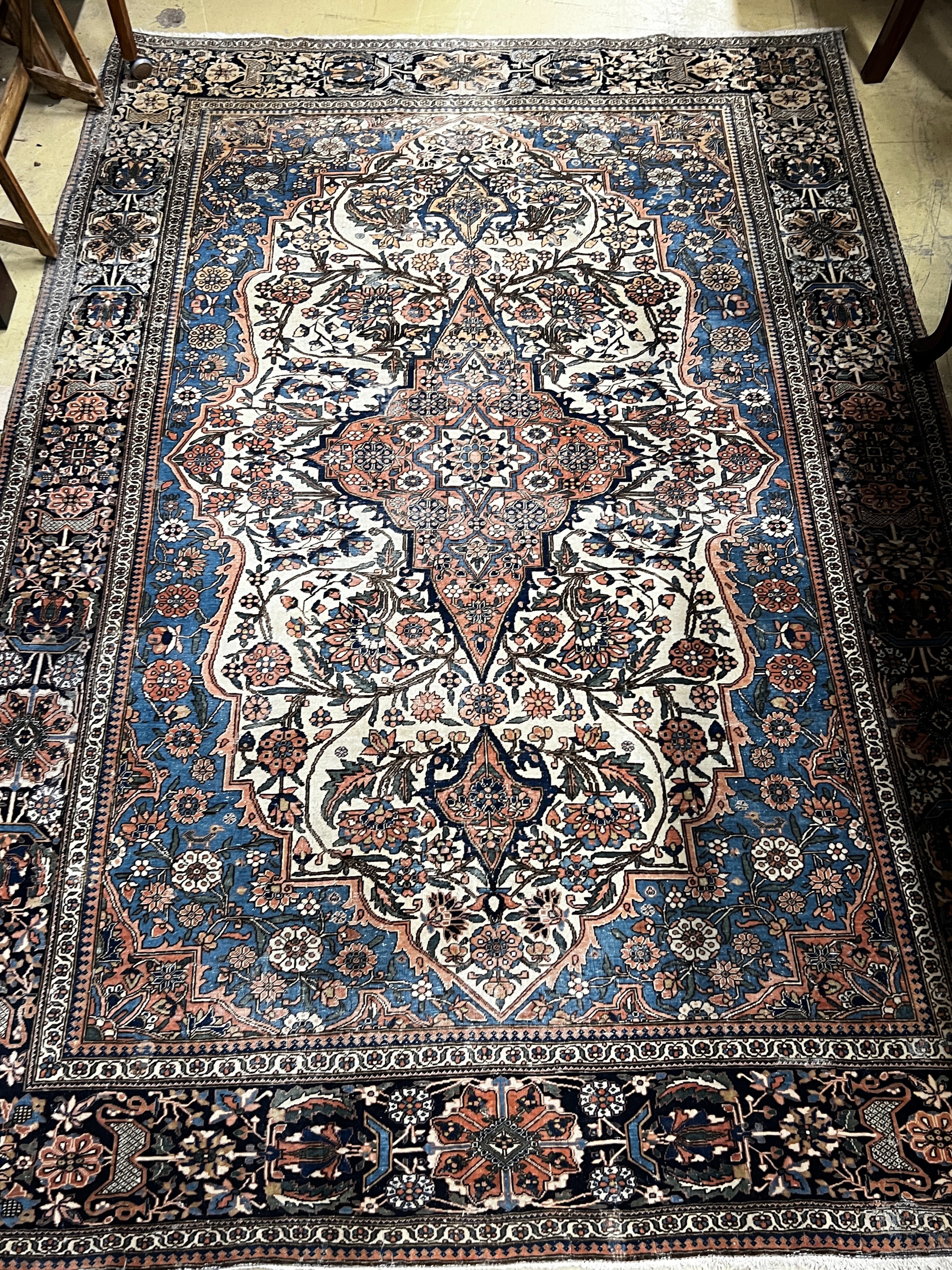 An antique Kashan blue ground rug, 207 x 140cm
